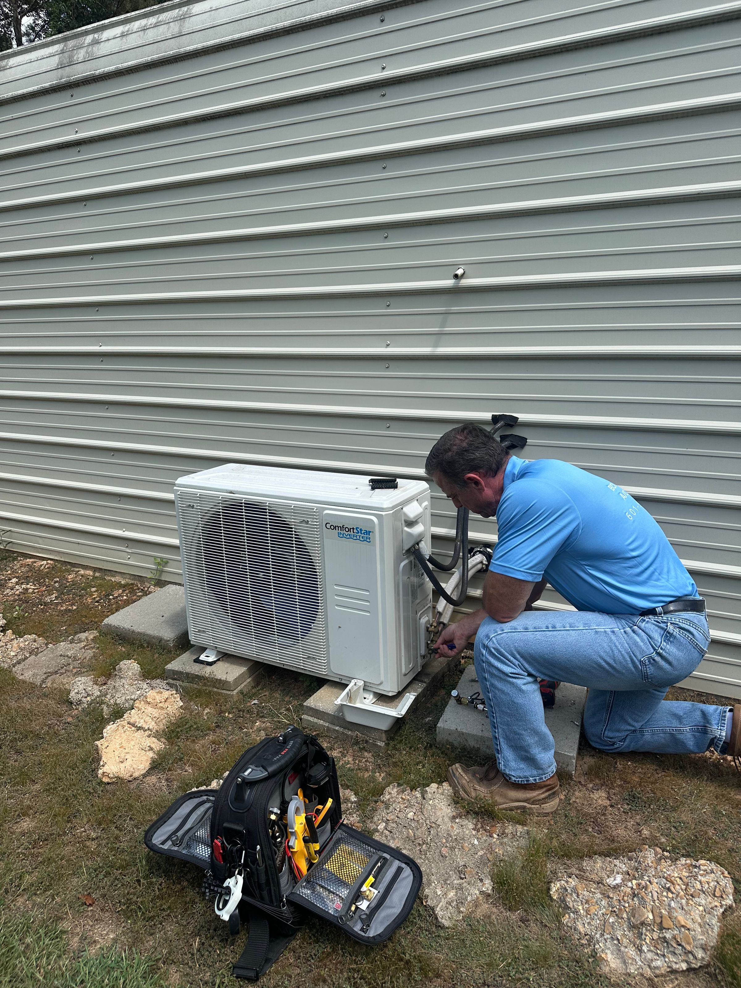 Boleware technician working beside a ductless mini-split outdoor unit